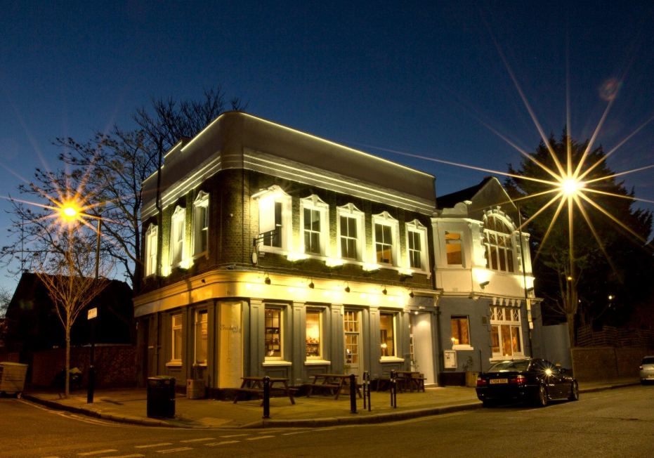 The Crooked Well in Camberwell, London, illuminated at night